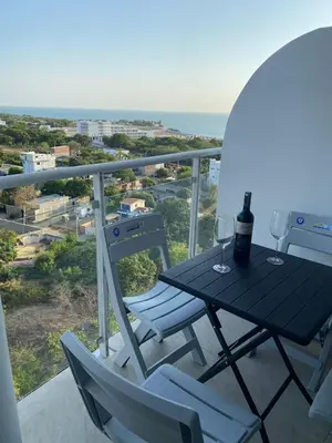 a table and chairs on a balcony with a view of the ocean at Apartamento LOFT INFINITY BLUE in Santa Marta