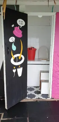 a door in a kitchen with some drawings on it at Casa en el agua in Tintipan Island