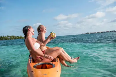 two people sitting on a raft in the water at Casa en el agua in Tintipan Island