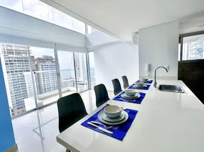 a dining room with a long table with chairs at apto navy 6 tripulantes in Cartagena de Indias