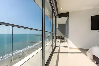 a bedroom with a view of the ocean at Sea View and Historic Center “Morros City” 2BR in Cartagena de Indias