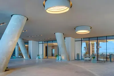 a large lobby with columns and tables and windows at Sea View and Historic Center “Morros City” 2BR in Cartagena de Indias