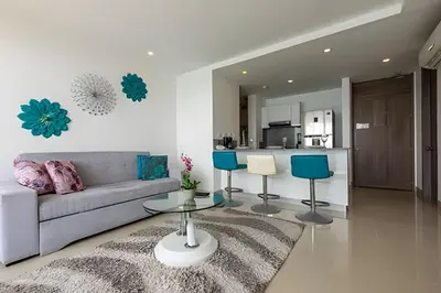 a living room with a couch and a table at Vista al Mar y Centro Histórico “Morros City” 26fl in Cartagena de Indias