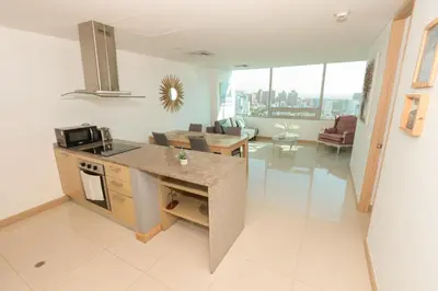 a kitchen and living room with a view of the city at Exclusive Loft Bluegardens Hilton Inn Apartments Barranquilla in Barranquilla