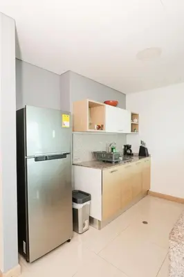 a kitchen with a stainless steel refrigerator at Exclusive Loft Bluegardens Hilton Inn Apartments Barranquilla in Barranquilla