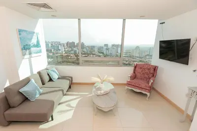 a living room with a couch and two chairs at Exclusive Loft Bluegardens Hilton Inn Apartments Barranquilla in Barranquilla