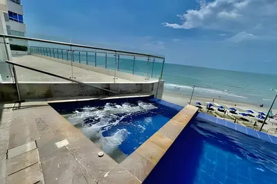 a swimming pool with the beach in the background at Piso 24 vista al mar 2BR in Cartagena de Indias