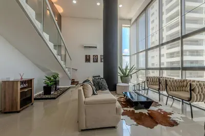 a large living room with couches and a staircase at Modern 3BR duplex Apt. Great view and location in Cartagena de Indias