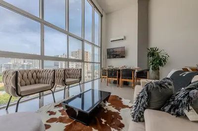 a living room with a couch and a table at Modern 3BR duplex Apt. Great view and location in Cartagena de Indias