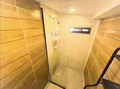 a shower with a glass door in a bathroom at A 5 mins de CC único King, Aire, Wi-Fi, Cocina in La Mina