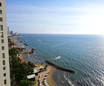 a view of a beach with a boat in the water at Luxury Apartment - Stunning Sea View in Cartagena de Indias