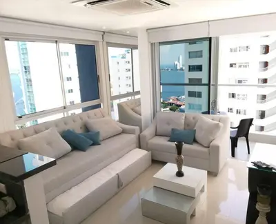 a living room with a white couch and large windows at Luxury Apartment - Stunning Sea View in Cartagena de Indias