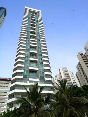 a tall building with palm trees in front of it at Luxury Apartment - Stunning Sea View in Cartagena de Indias