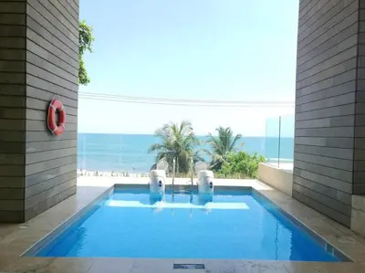 a swimming pool with a view of the ocean at Luxury Apartment - Stunning Sea View in Cartagena de Indias