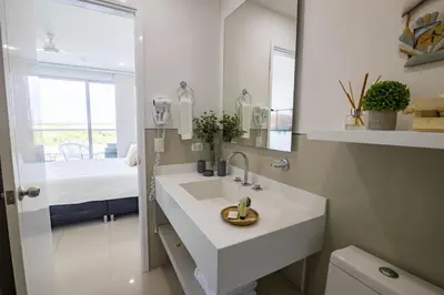 a white bathroom with a sink and a mirror at Apto en Morros Epic Cartagena in Cartagena de Indias