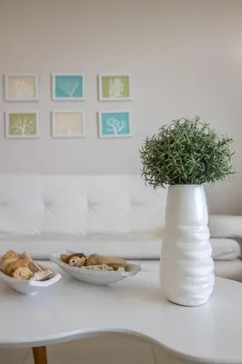 a white vase with a potted plant on a table at Apto en Morros Epic Cartagena in Cartagena de Indias