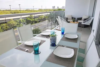 a dining room with a balcony with a table and chairs at Apto en Morros Epic Cartagena in Cartagena de Indias