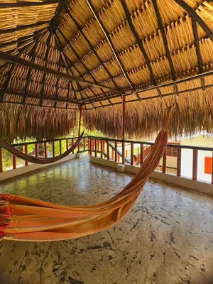 a hammock in a straw straw roofed building at Cerca a Coveñas- Cabaña El Paraiso - Mar - Arena in San Antero