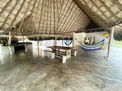 a pavilion with a picnic table and a hammock at La Felicidá in Cartagena de Indias