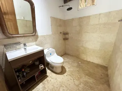 a bathroom with a toilet and a sink and a mirror at La Felicidá in Cartagena de Indias