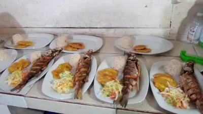 a group of plates of food on a counter at Condominio de Cabañas Cangrejo Azul in El Bobo