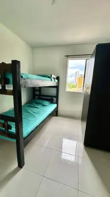 a room with two bunk beds and a window at Apartamento amoblado cerca al mar in Cartagena de Indias