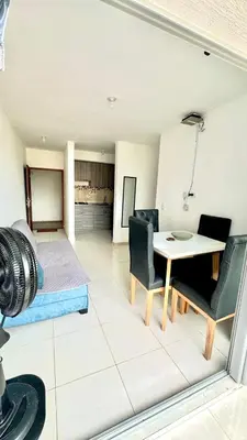 a living room with a table and chairs at Apartamento amoblado cerca al mar in Cartagena de Indias