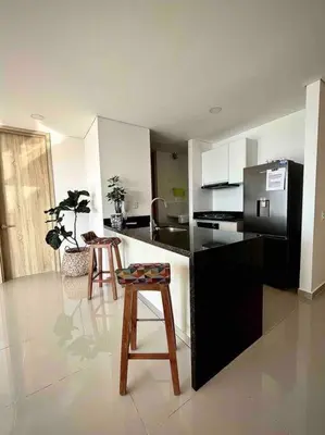 a kitchen with a black refrigerator and two stools at CasaMaha Cartagena Espectacular Apartamento in Cartagena de Indias