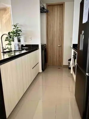 a kitchen with a black refrigerator and a counter at CasaMaha Cartagena Espectacular Apartamento in Cartagena de Indias
