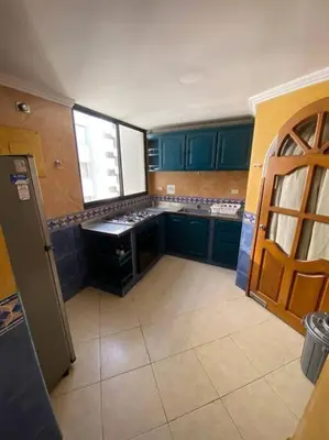 a kitchen with blue cabinets and a sink in it at Cómodo y acogedor departamento in Cartagena de Indias
