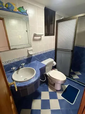 a blue and white bathroom with a toilet and a sink at Cómodo y acogedor departamento in Cartagena de Indias