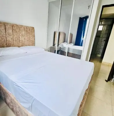 a white bed in a room with a mirror at Apartamento Villa San Pedro in San Roque