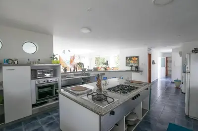 a kitchen with a stove and a counter top at Cabana Mangle Playa Privada in San Antero