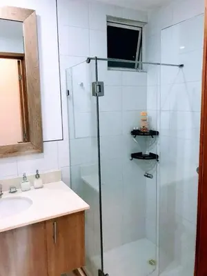 a bathroom with a glass shower and a sink at exclusivo edificio con piscina en primera linea de playa in Cartagena de Indias