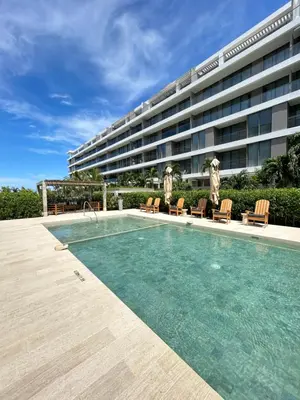 a swimming pool in front of a large building at Lujo y relax frente al mar en Morros Eos in Cartagena de Indias