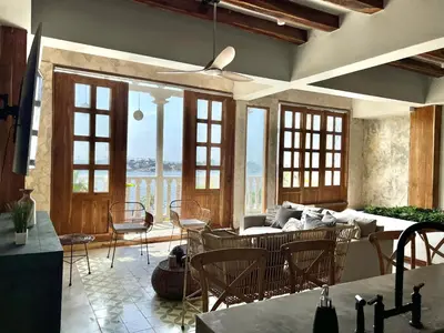 a living room with a couch and a table and chairs at Santa Isabel - Villa de diseño con vistas privilegiadas y piscina in Cartagena de Indias