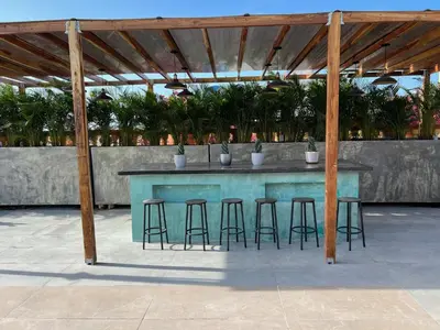 a blue table with bar stools under a pavilion at Santa Isabel - Villa de diseño con vistas privilegiadas y piscina in Cartagena de Indias