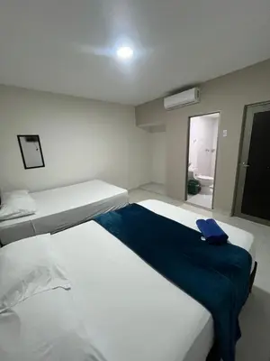 a bedroom with two beds and a blue blanket at Hotel Stay Golden in Cartagena de Indias