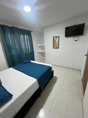 a bedroom with a bed and a flat screen tv at Hotel Stay Golden in Cartagena de Indias