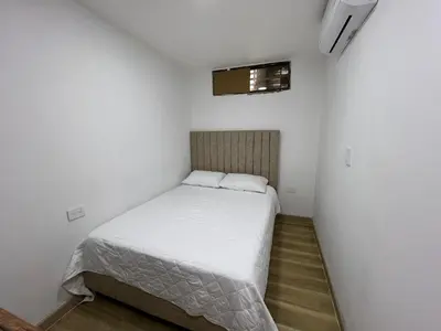 a small bedroom with a bed in a room at Portofino Bocagrande 3 habitaciónes in Cartagena de Indias