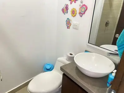 a bathroom with a white toilet and a sink at Edificio Mares de Coveñas in Coveñas