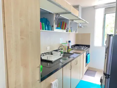 a kitchen with a sink and a refrigerator at Edificio Mares de Coveñas in Coveñas