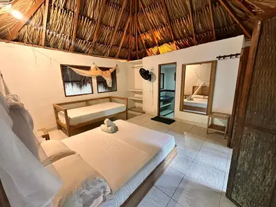 a bedroom with a bed and a mirror at Orika del Mar Hotel in Isla Grande
