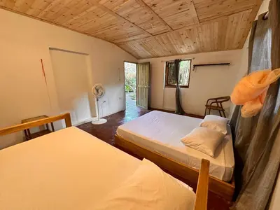 a bedroom with two beds and a fan at Orika del Mar Hotel in Isla Grande