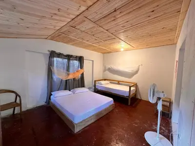 a bedroom with two beds and a wooden ceiling at Orika del Mar Hotel in Isla Grande