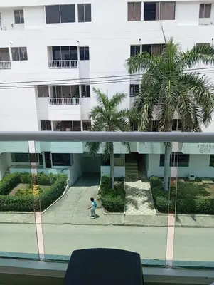 a little boy walking down a sidewalk in front of a building at Apartamento Cartagena cerca a la playa in Cartagena de Indias