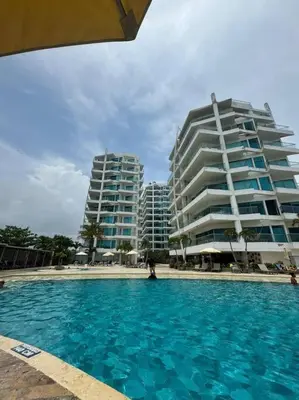 a swimming pool in front of two tall buildings at Amazing Beachfront Apartment in Cartagena de Indias