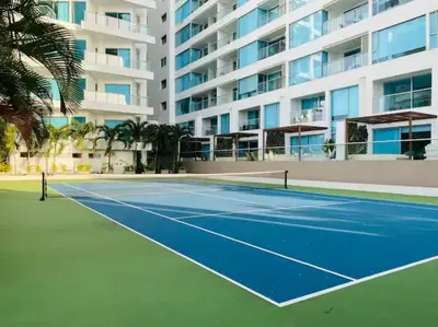 a tennis court in front of a building at Amazing Beachfront Apartment in Cartagena de Indias