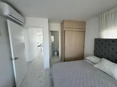 a bedroom with a bed and a bathroom at Portofino Bocagrande 2 habitaciones in Cartagena de Indias