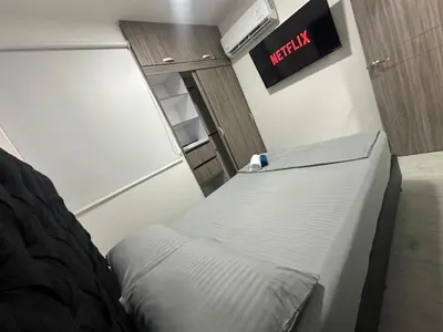 a bed in a room with a sign on the wall at 3BR AC LUXURY APARTMENT CLOSE TO THE AIRPORT Beach & THE HISTORIC CENTER in Cartagena de Indias